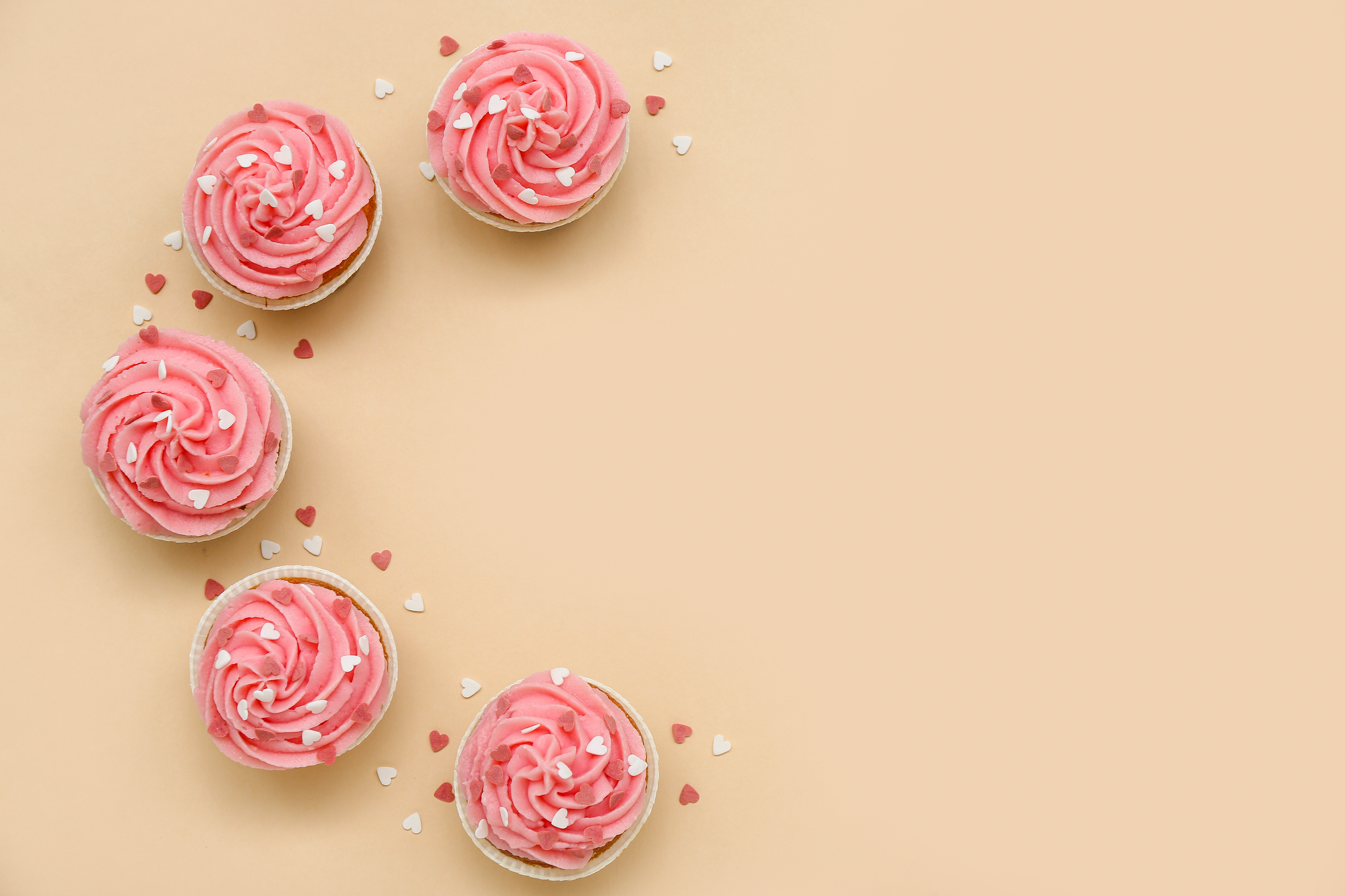 Frame Made of Tasty Cupcakes with Hearts for Valentine's Day on Beige Background